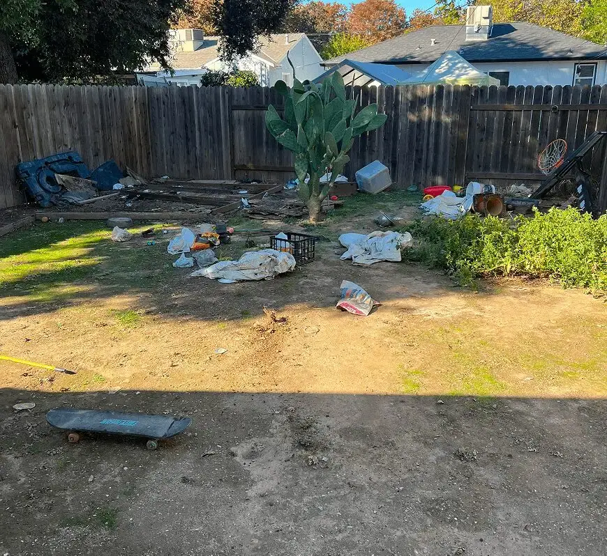 Backyard cleared of scattered junk and debris