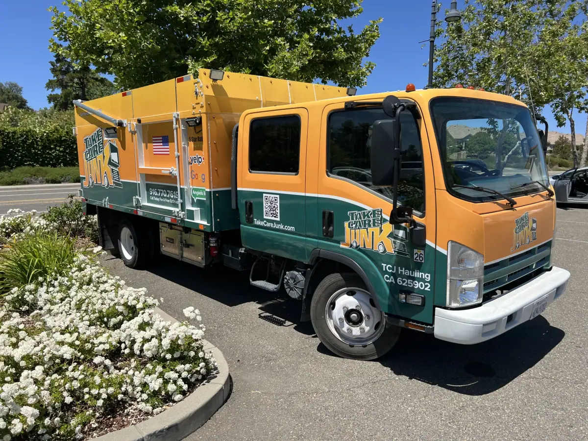 Take Care Junk hauling truck parked in a Sacramento neighborhood